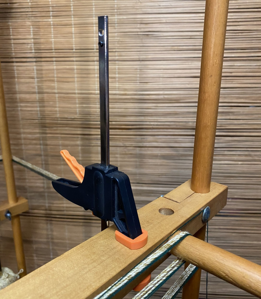 Photo of a quick-release clamp attached to a warping board.